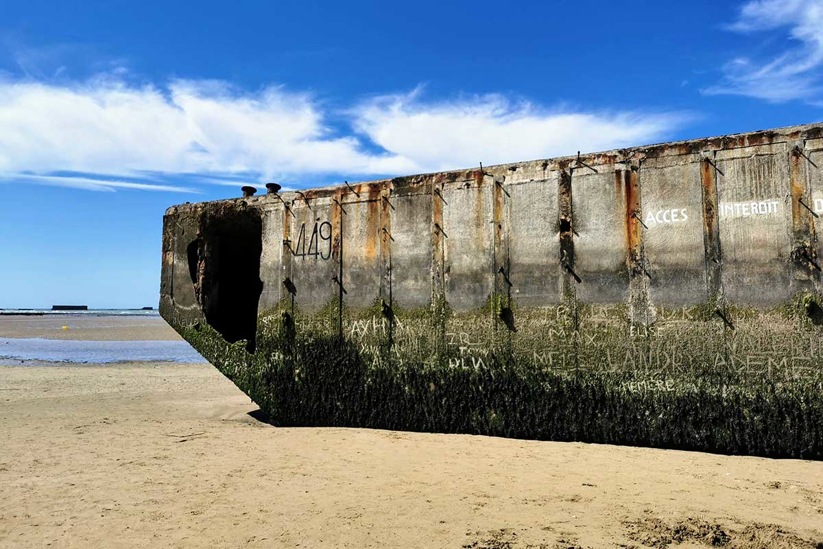 Weathered World War II concrete fortification remains on a Normandy D-Day landing beach